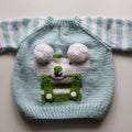 Knitted sweater with a cartoon character design on a plain background